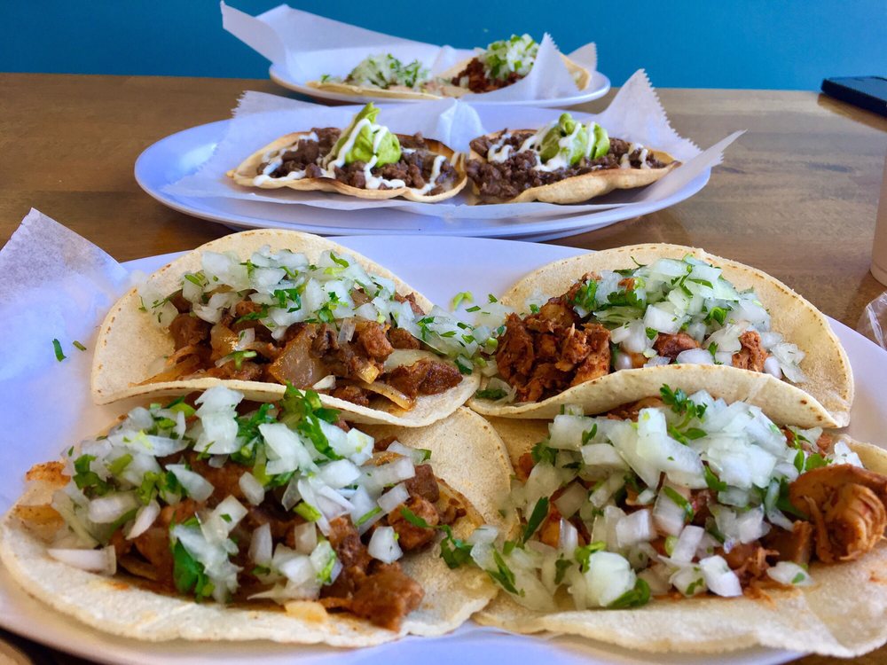 Spread of tacos and vampiros on the table