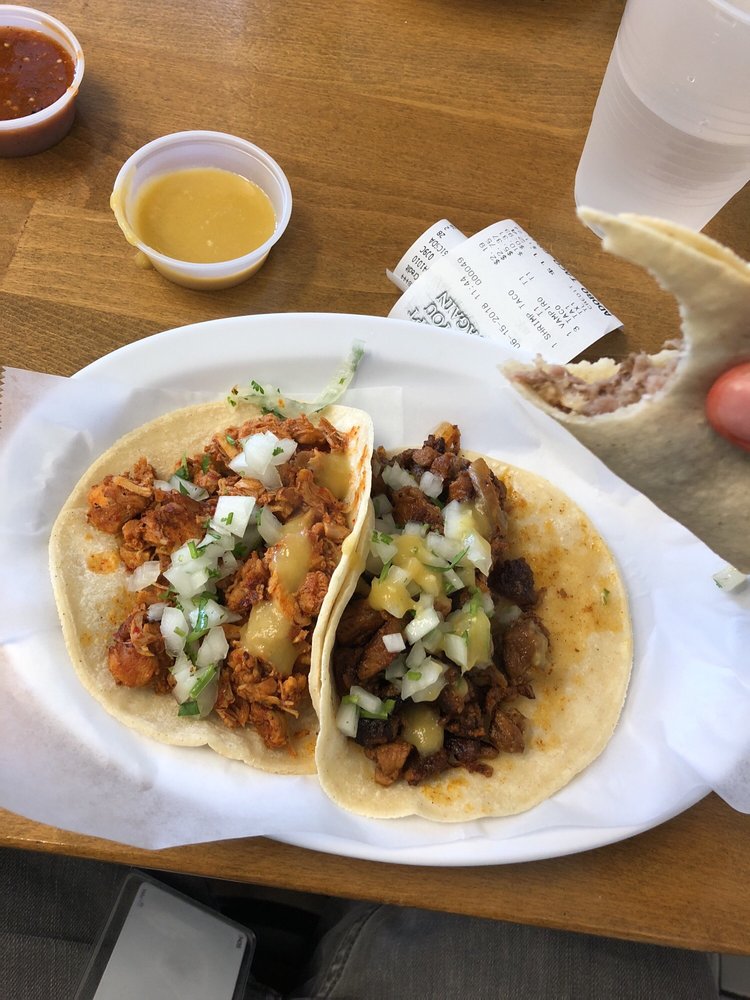 Two tacos with salsa roja and salsa verde